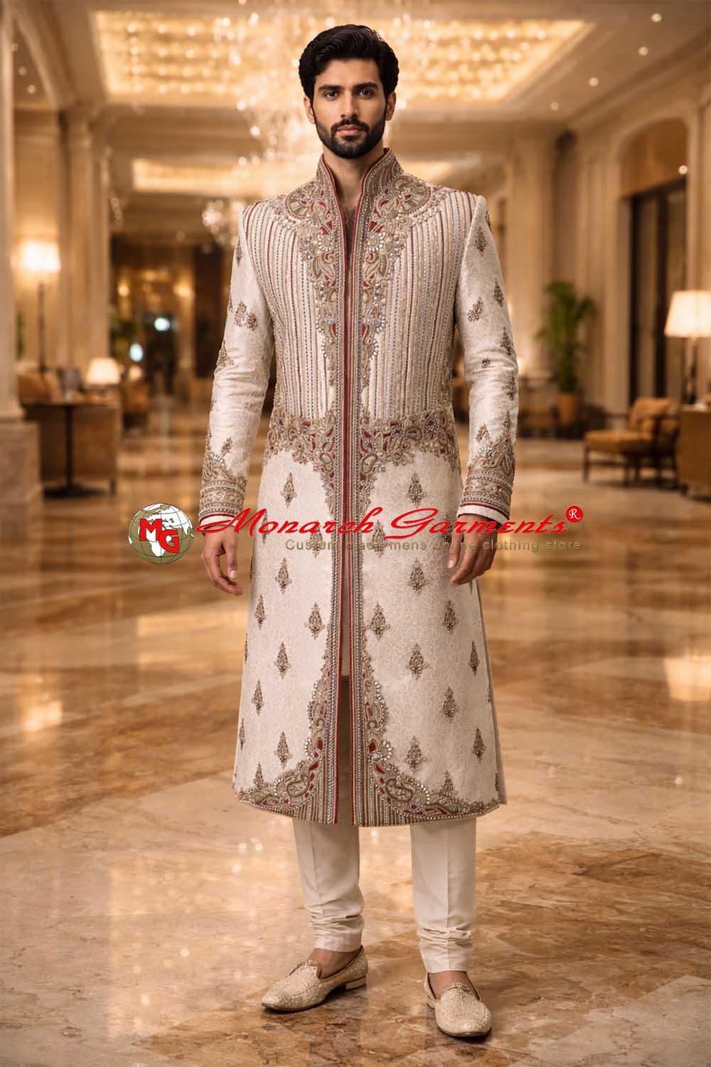 Indian groom wearing beige jacquard embroidered sherwani with red accents by Monarch Garments