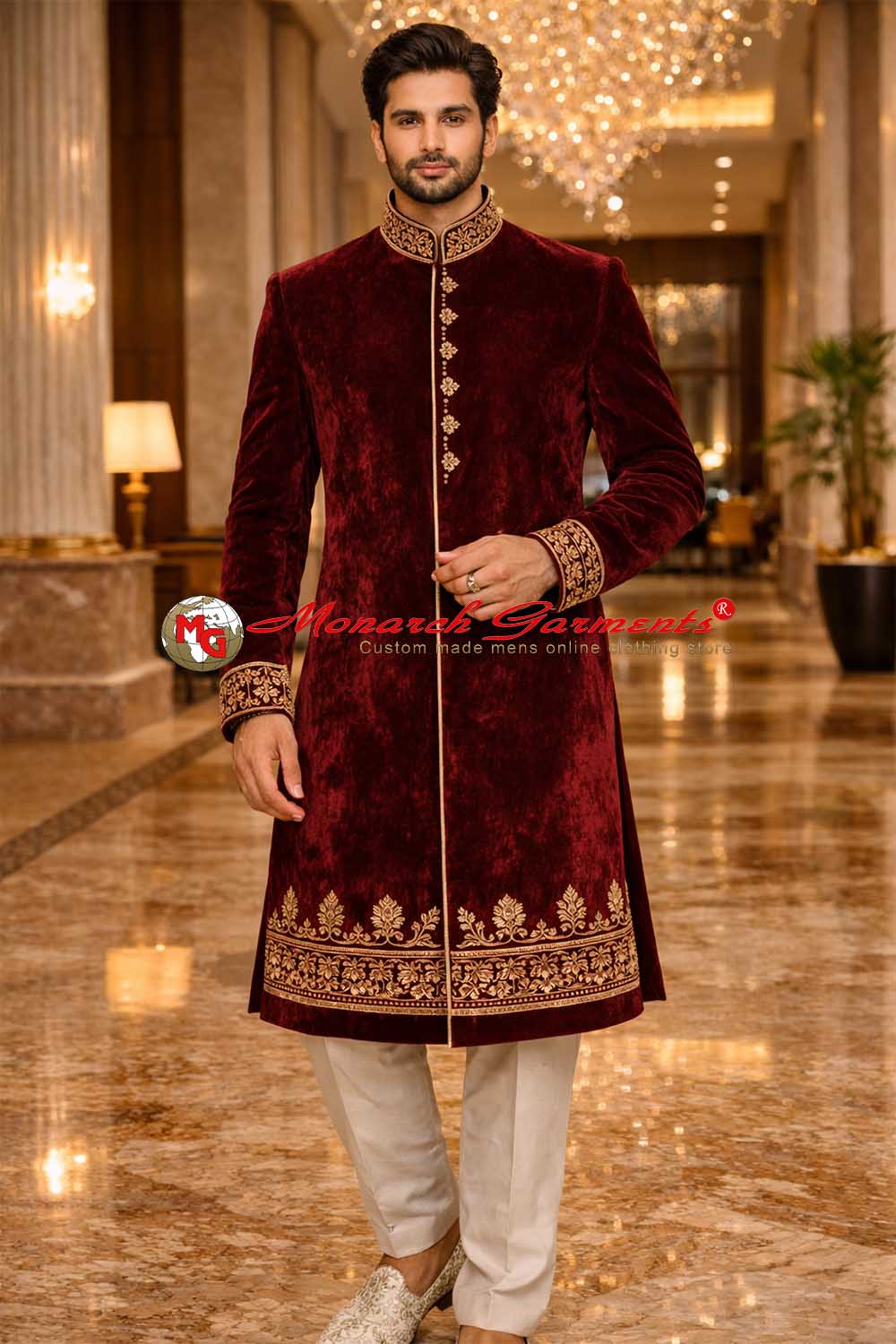 Indian groom wearing maroon velvet wedding sherwani with gold embroidery by Monarch Garments