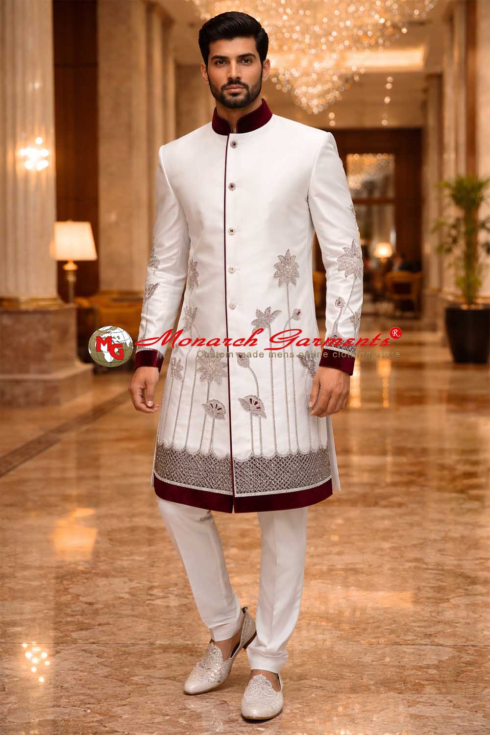 Indian groom wearing white polyester wedding sherwani with maroon velvet collar and embroidery by Monarch Garments